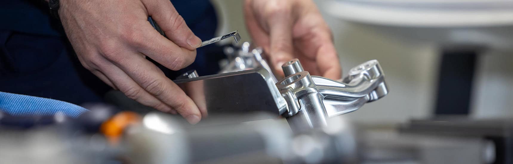a close-up of hands holding a piece of metal